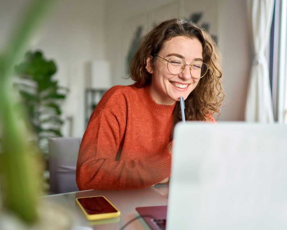 Middle school student connecting to an online class on a laptop at home.